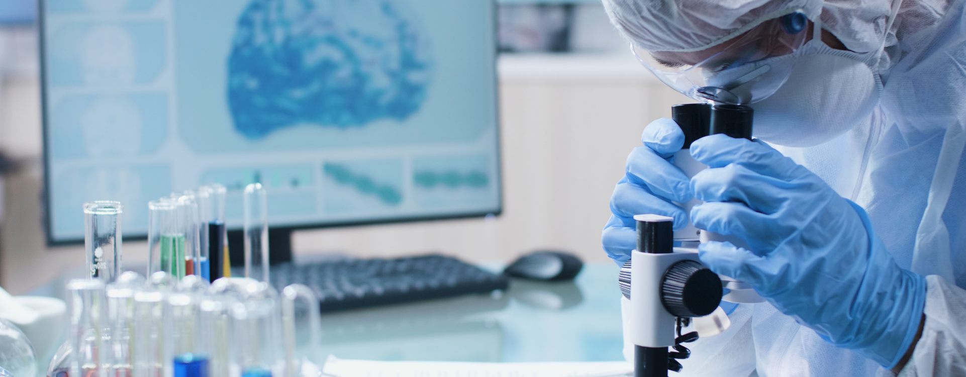Researcher looking through a microscope