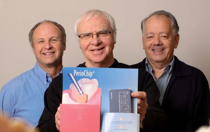 Researchers holding a dental device