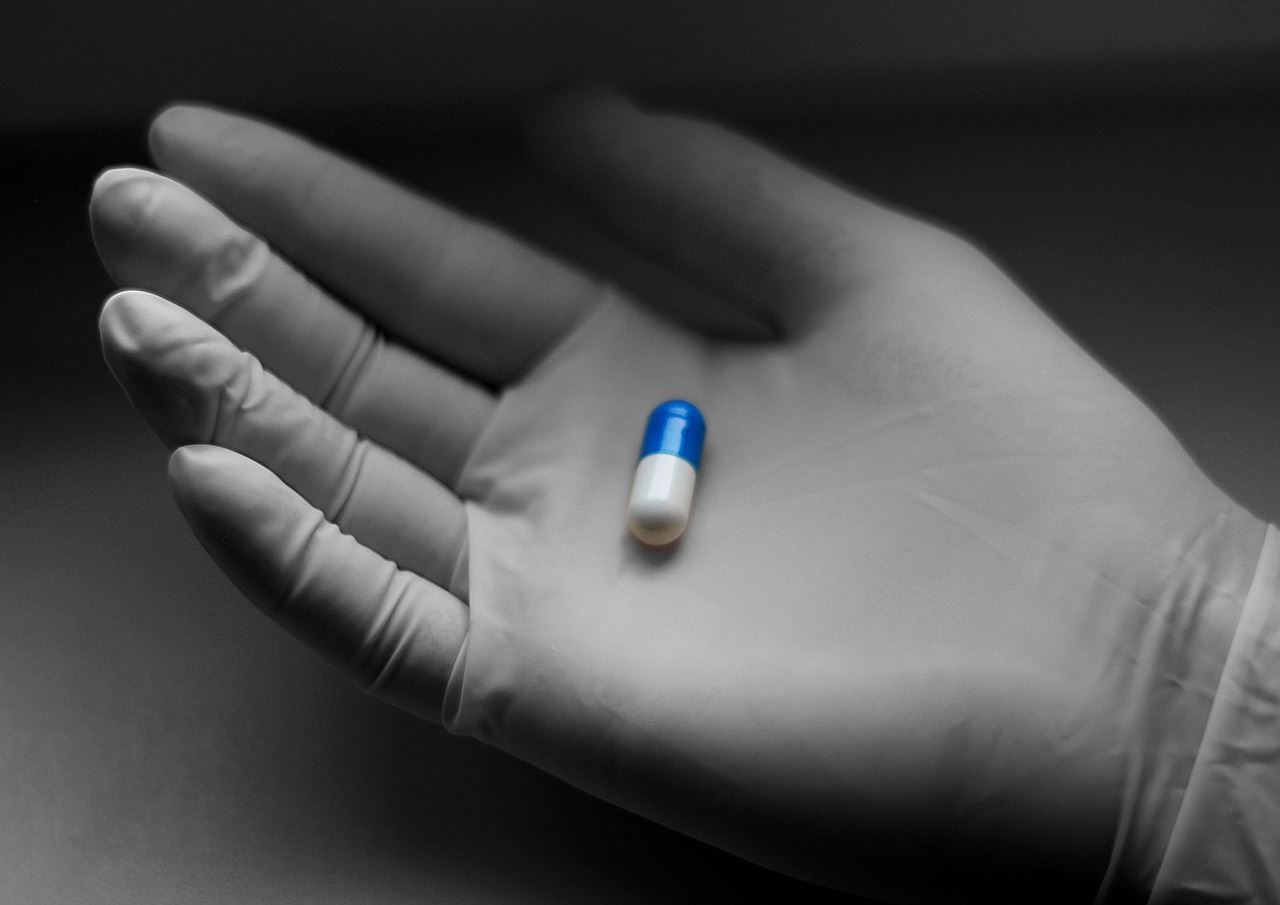 Researcher holding a pill