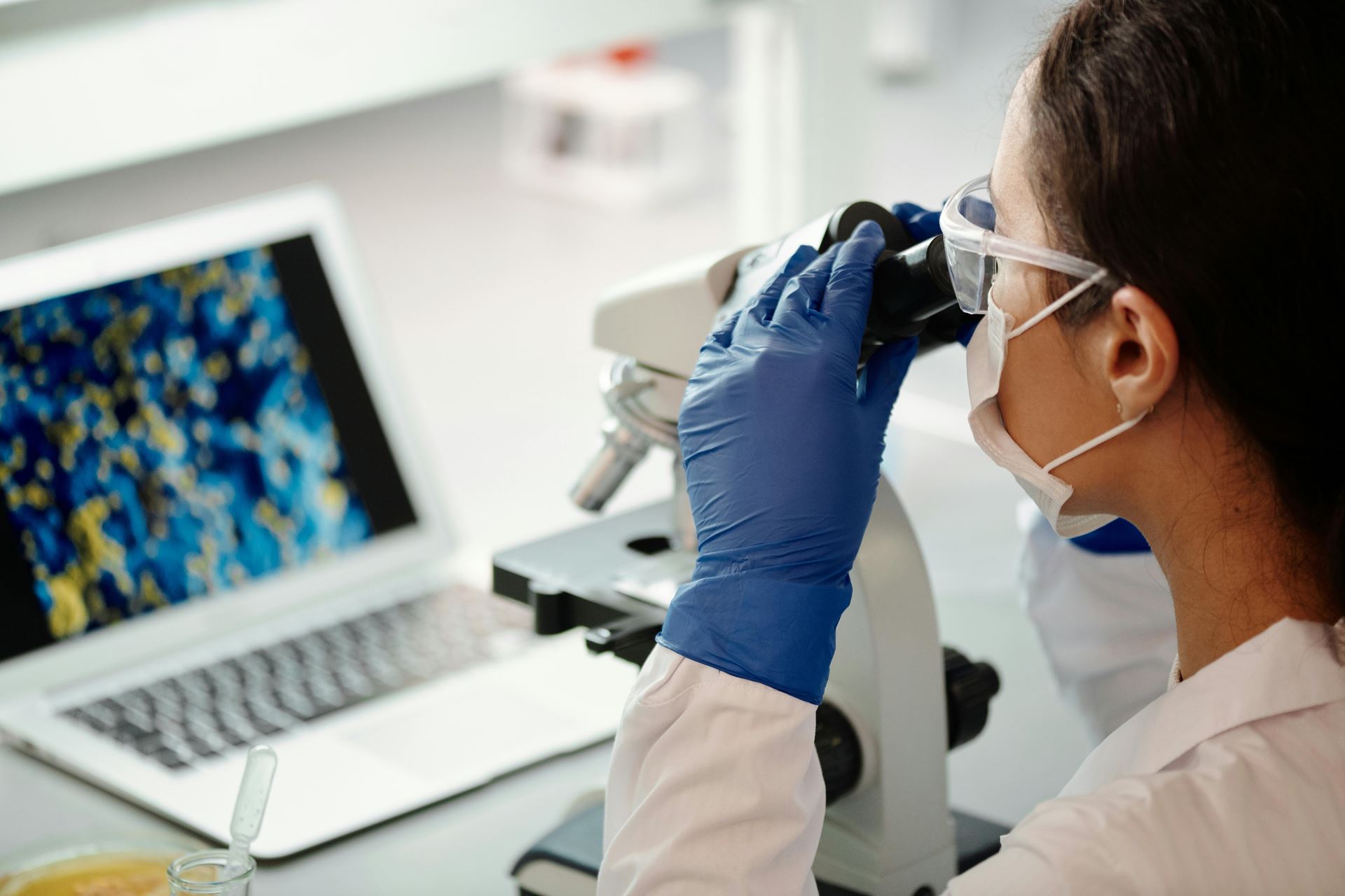 Researcher looking through a microscope